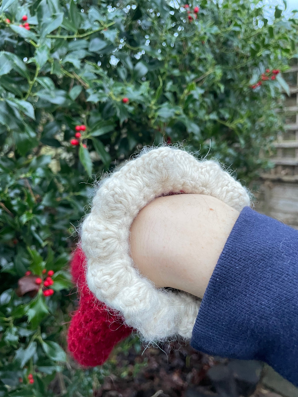 Red crochet mittens with a cream frill