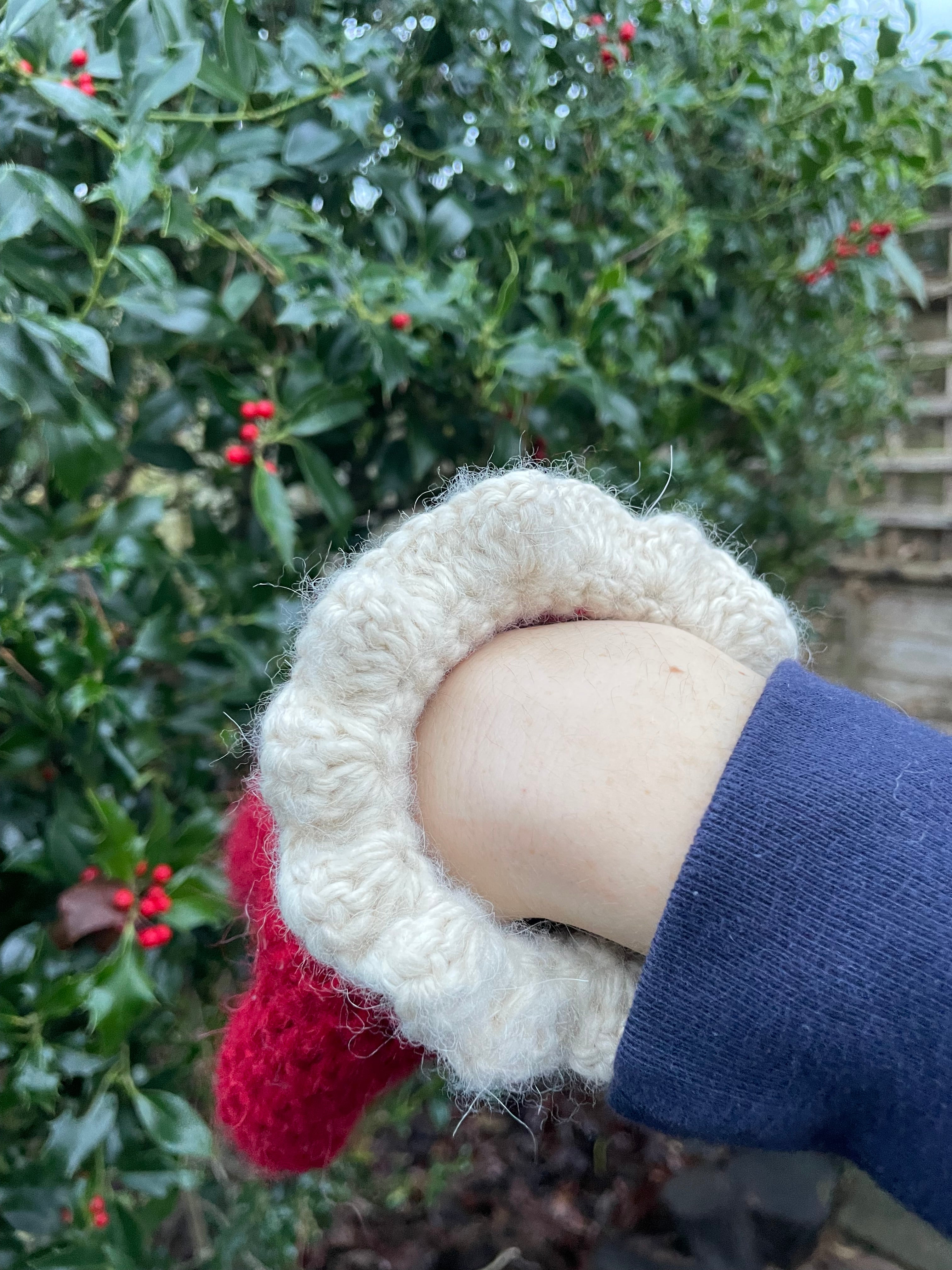 Red crochet mittens with a cream frill