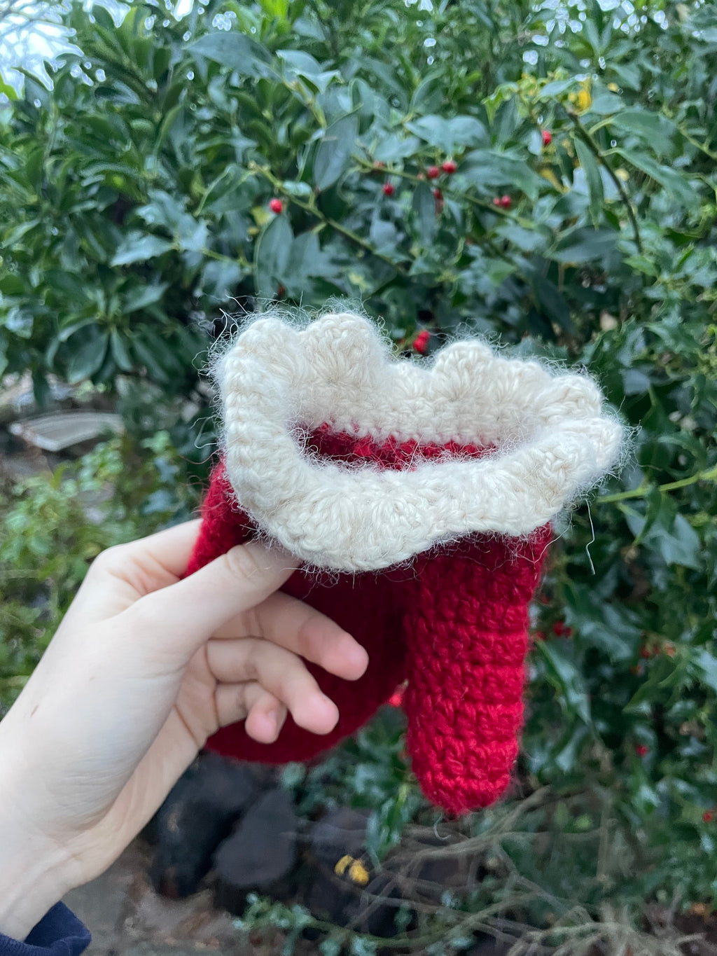 Red crochet mittens with a cream frill