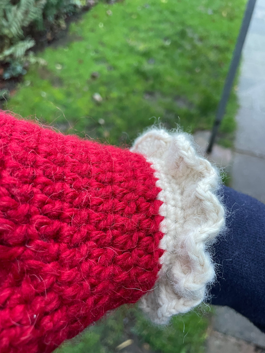 Red crochet mittens with a cream frill