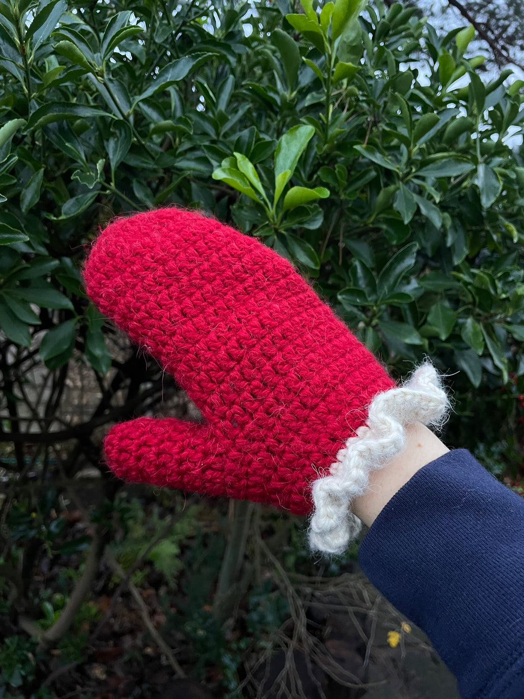 Red crochet mittens with a cream frill