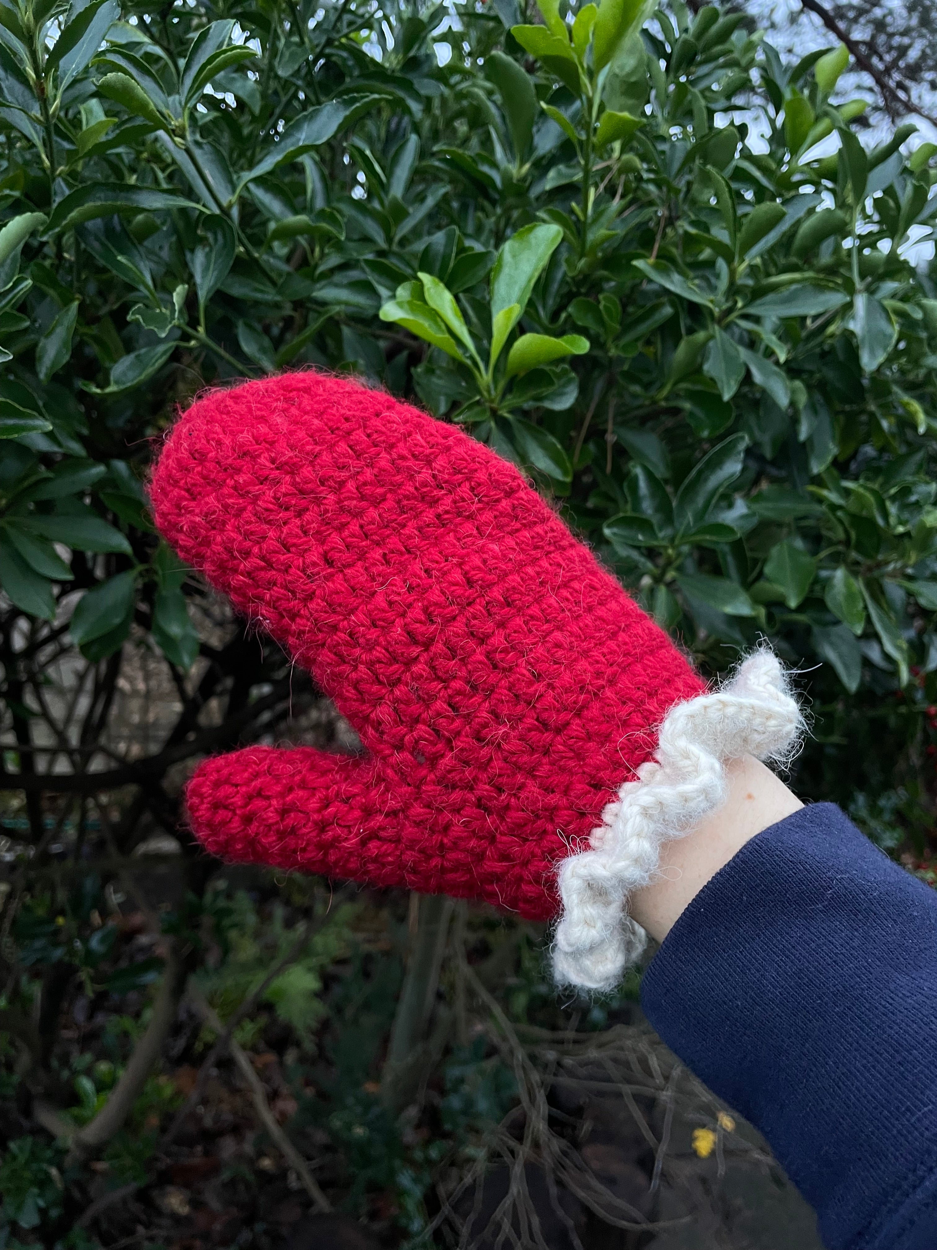 Red crochet mittens with a cream frill