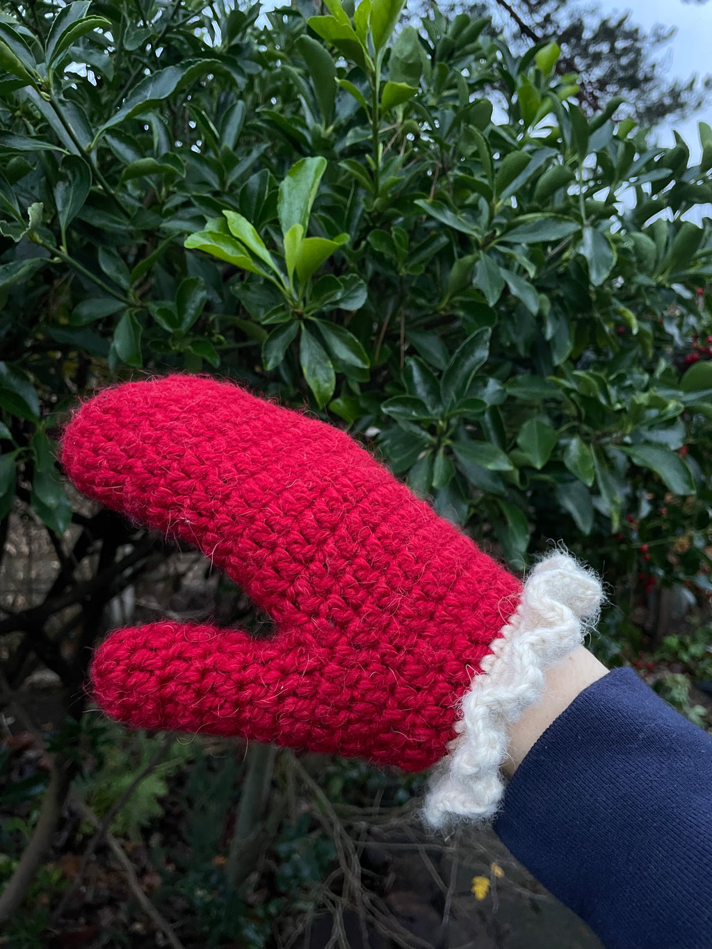 Red crochet mittens with a cream frill
