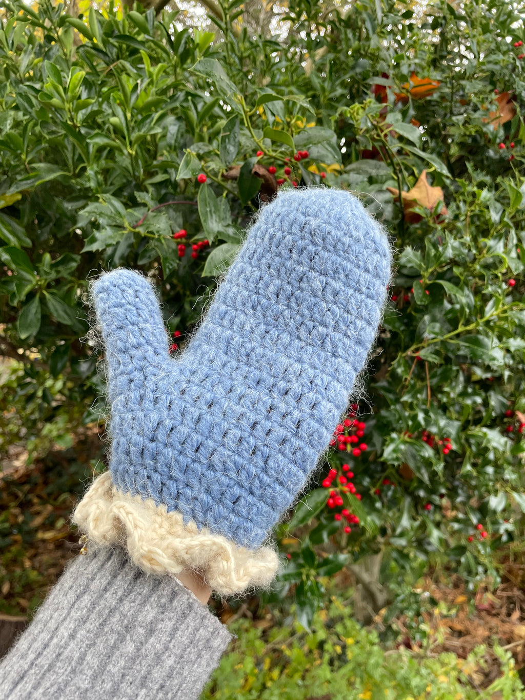 Blue crochet mittens with cream frill