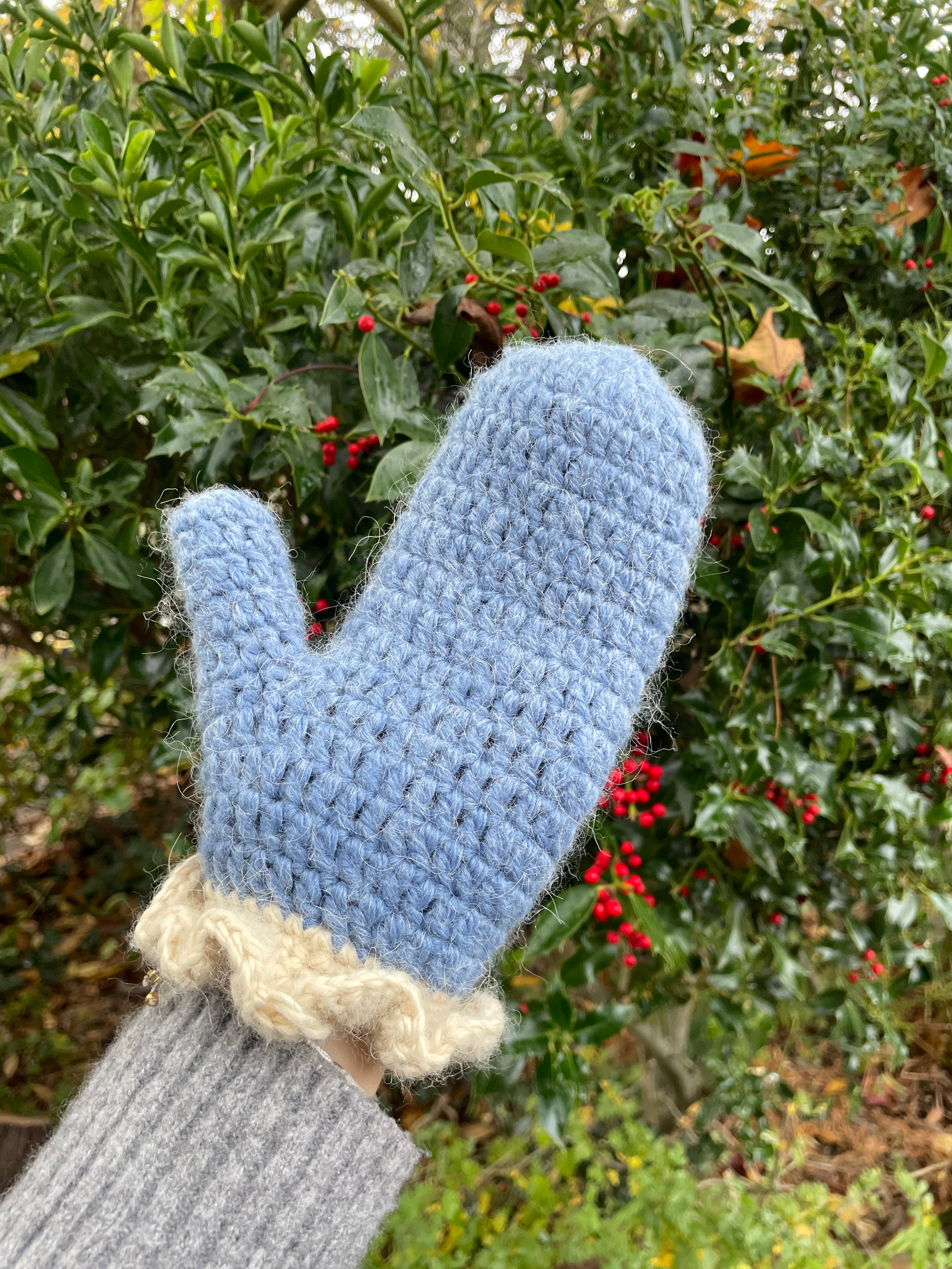 Blue crochet mittens with cream frill